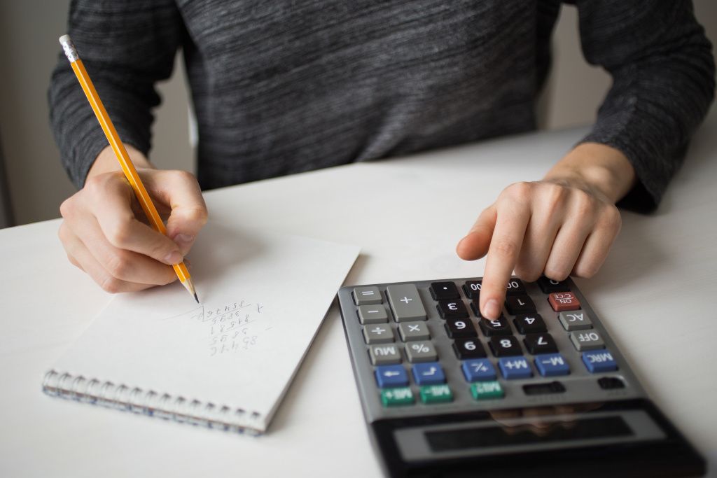 closeup-accountant-using-calculator-writing.jpg